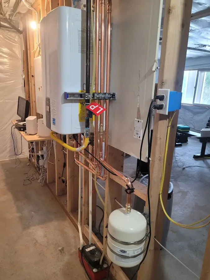 Licensed plumber repairing a kitchen sink in Milton